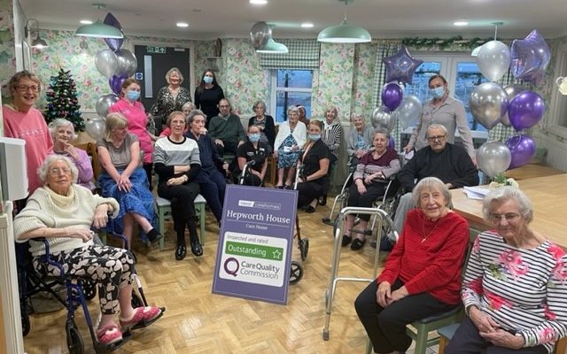 Residents and staff at Hepworth House show off their Outstanding rating