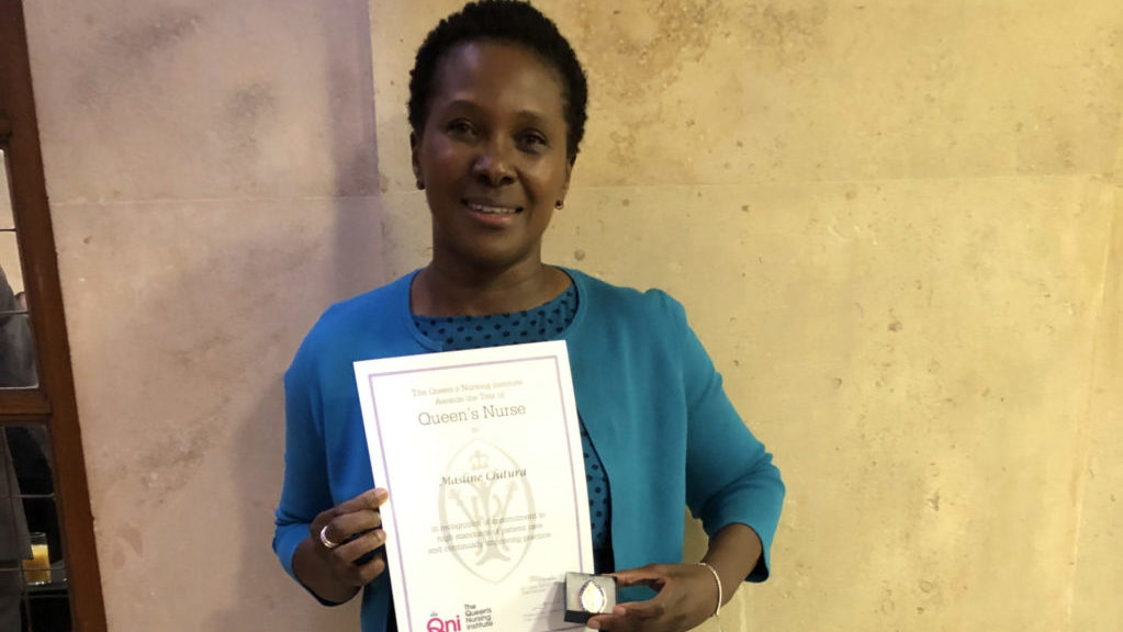 Masline Chitura with her Queen’s Nurse badge and certificate