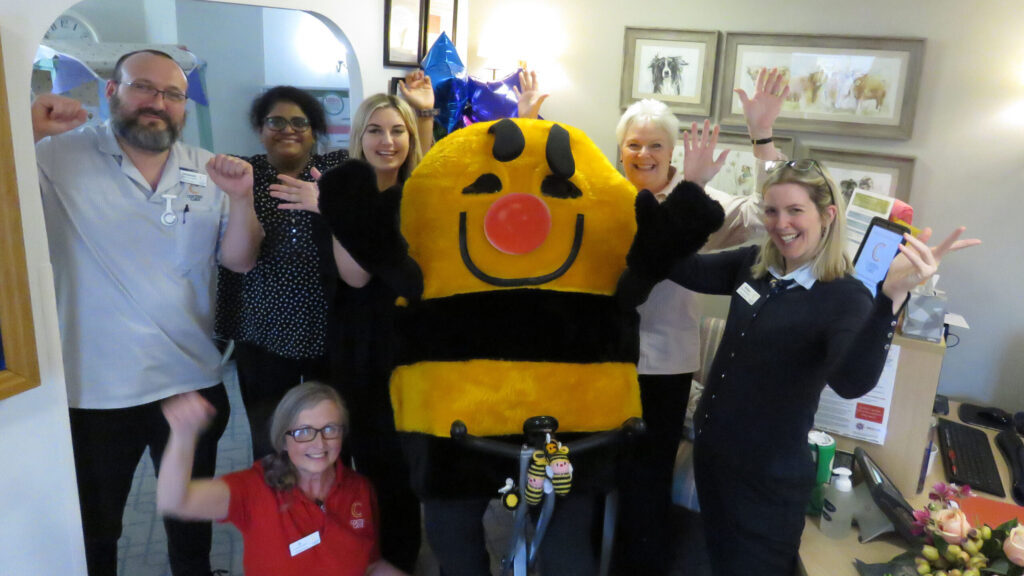 Woodpeckers colleagues Immanuel Verhoeven, home manager Priya Joseph, Hayley McEvoy, Alice Smee, Helene Palmer and, seated, Jo Anderson celebrated with the Honey Pot mascot