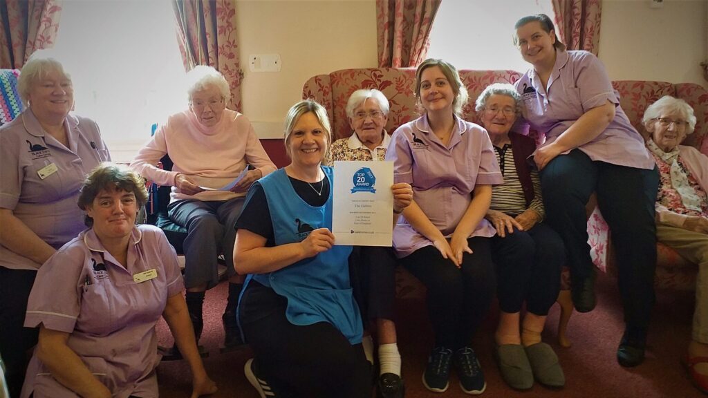 Residents and staff at The Gables show off their award