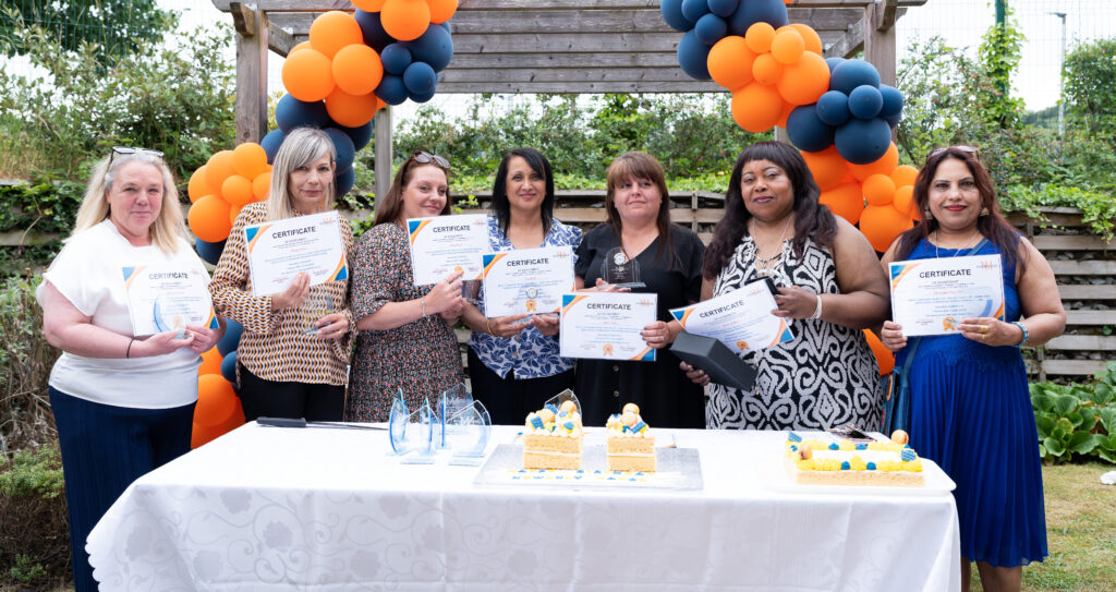 Staff members and Newbury Manor's manager received a personalised glass award, clock, and certificate as tokens of recognition