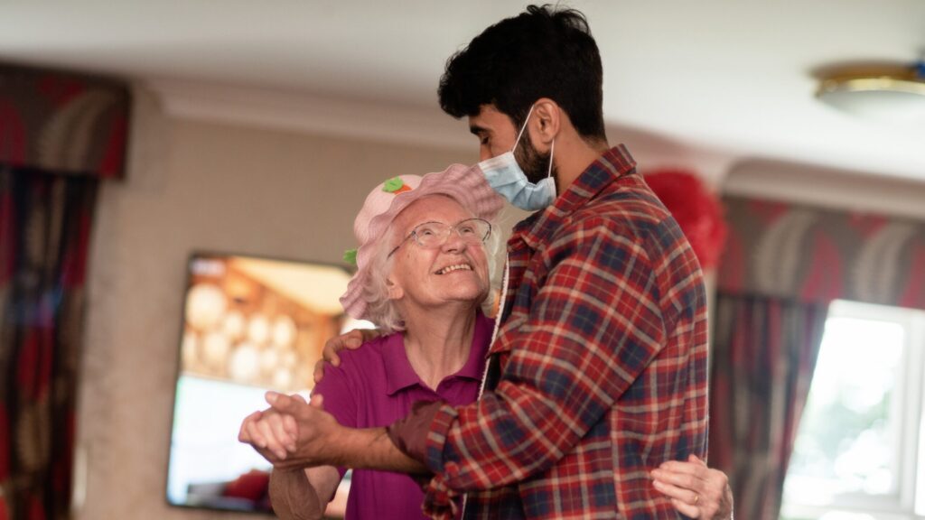 A resident dances with a member of Fevered Sleep at Excelcare's Sherrell House. Credit: Camilla Greenwell