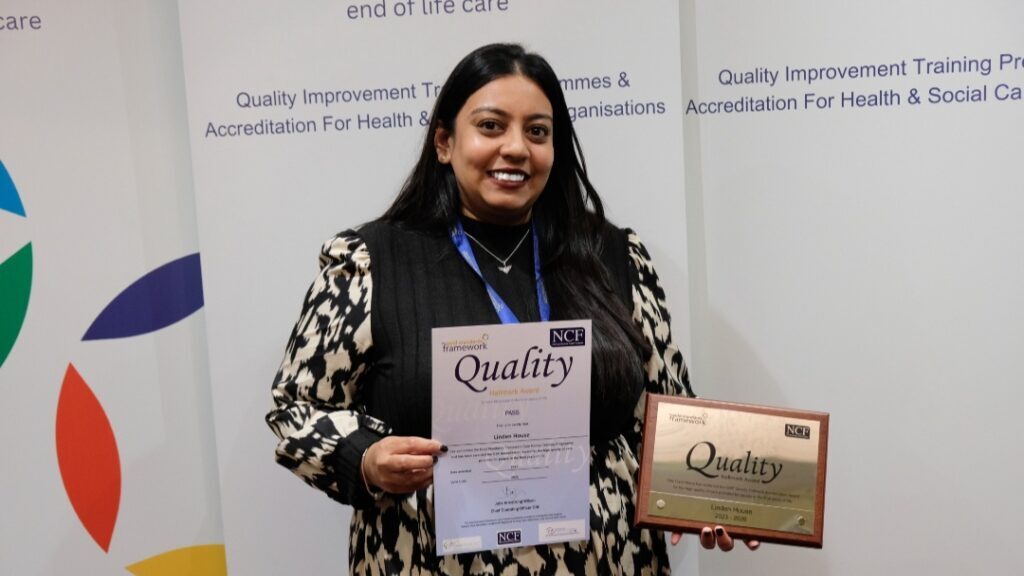 Home manager, Reshma Tupsy, shows off Linden House's GSF award
