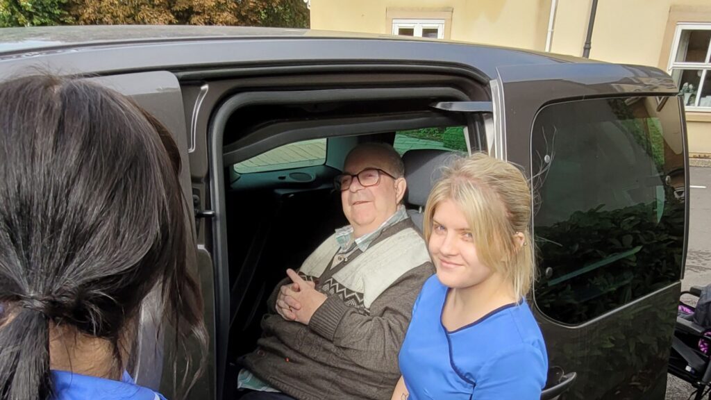 Resident Les White with healthcare assistant Jess with the new wheelchair accessible vehicle