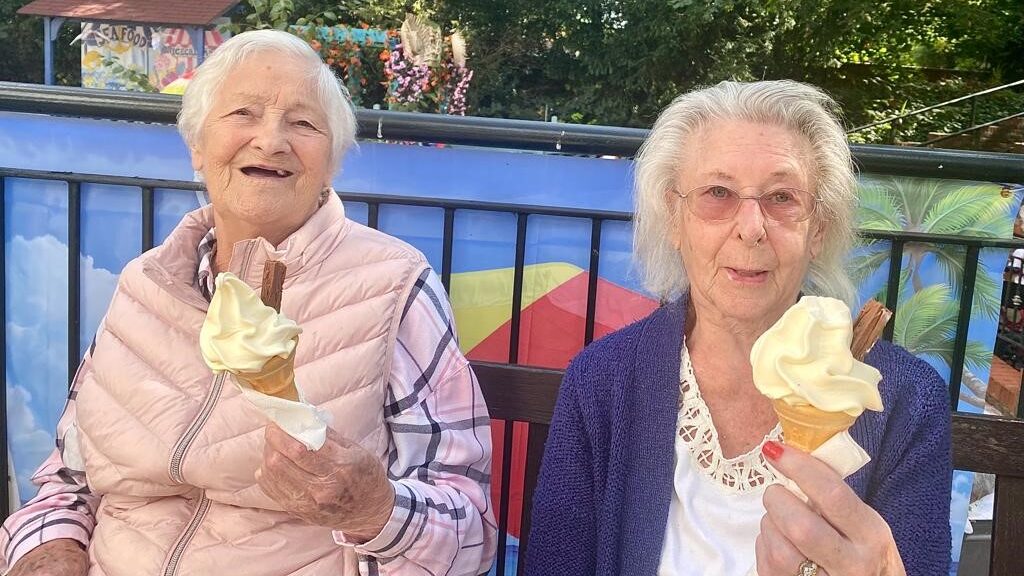 Residents Hazel and Maureen enjoy an ice cream at the official of the beach oasis at Old Shenfield Place