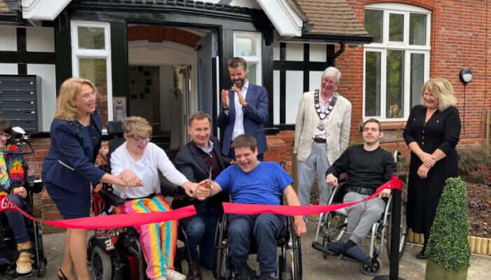 Chancellor Jeremy Hunt (fourth left) helps to officially opening Voyage Care's supported living service in Hindhead