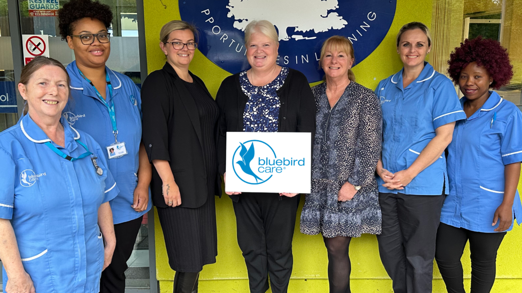 Sonia White, centre, welcomes staff from Bluebird Care to Osborne School as they launch their innovative new partnership