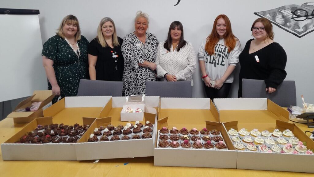 Darlington support office colleagues decorating cupcakes ahead of Cake4Kindness Day