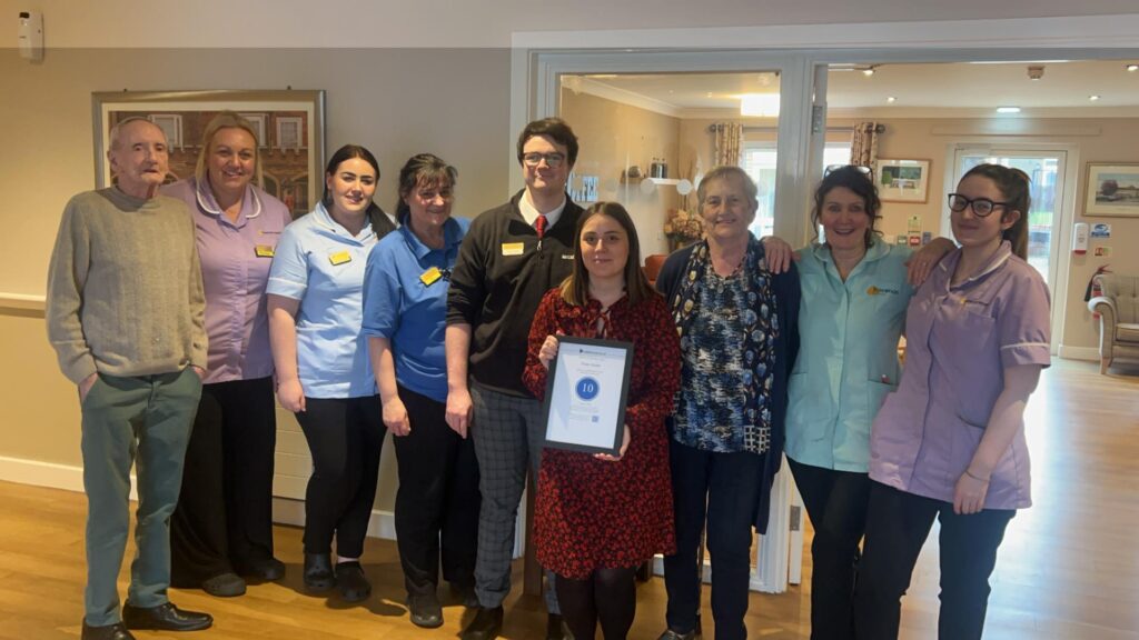 Top marks! Four Acres staff show off their 10 out of 10 carehome.co.uk review rating