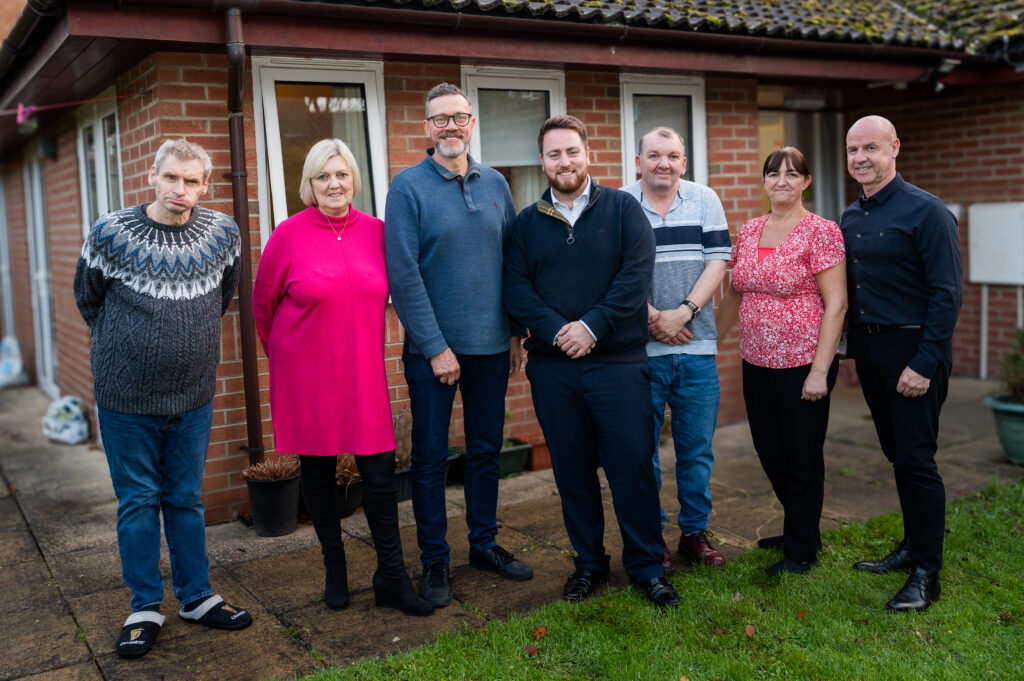 Councillor Paul McInnes and Jacob Young MP is (third and fourth from left) with service users and staff at Voyage Care’s Bridge Court care home