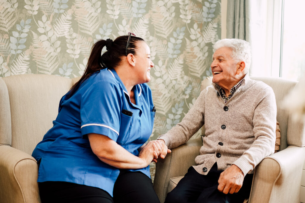 Care worker holding hand of older person